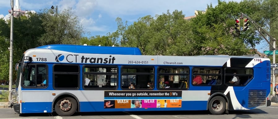 2. A CT Transit bus  featuring Our Humanity 3Ws Wash Wear Wait banner