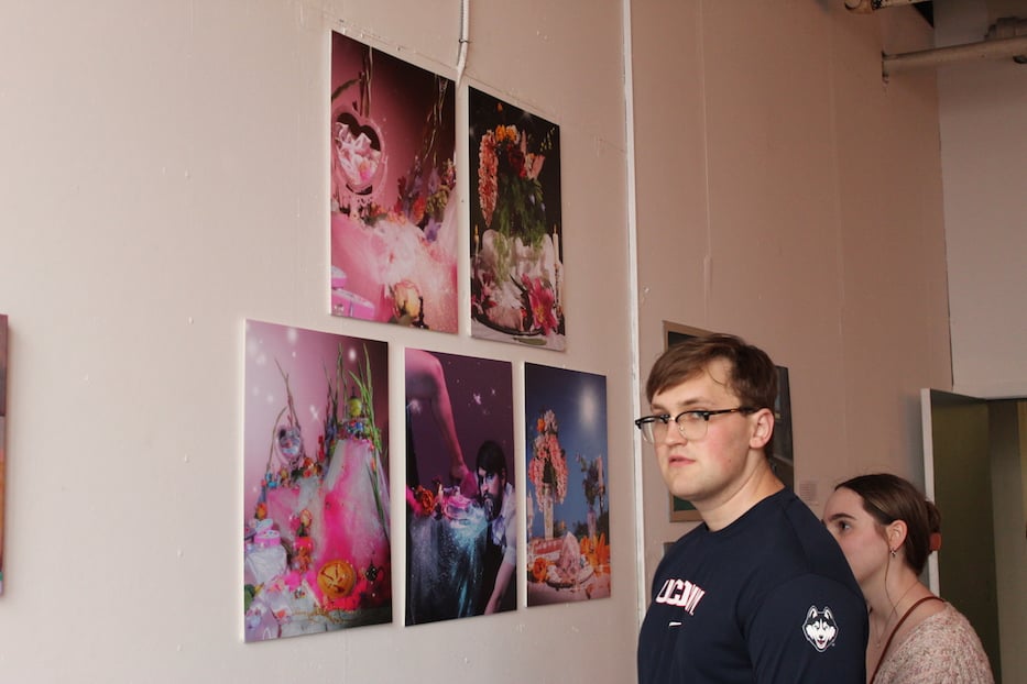 Attendees pause in front of Max Pollack_s photographs, which take inspiration from Pollack_s gender transition