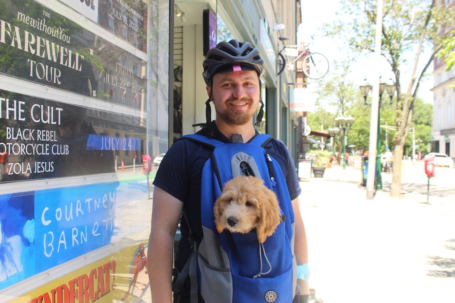 Elias Estabrook, a member of New Haven Coalition for Active Transportation, with Wally, a 10-month-old puppy who_s training to become an emotional support dog