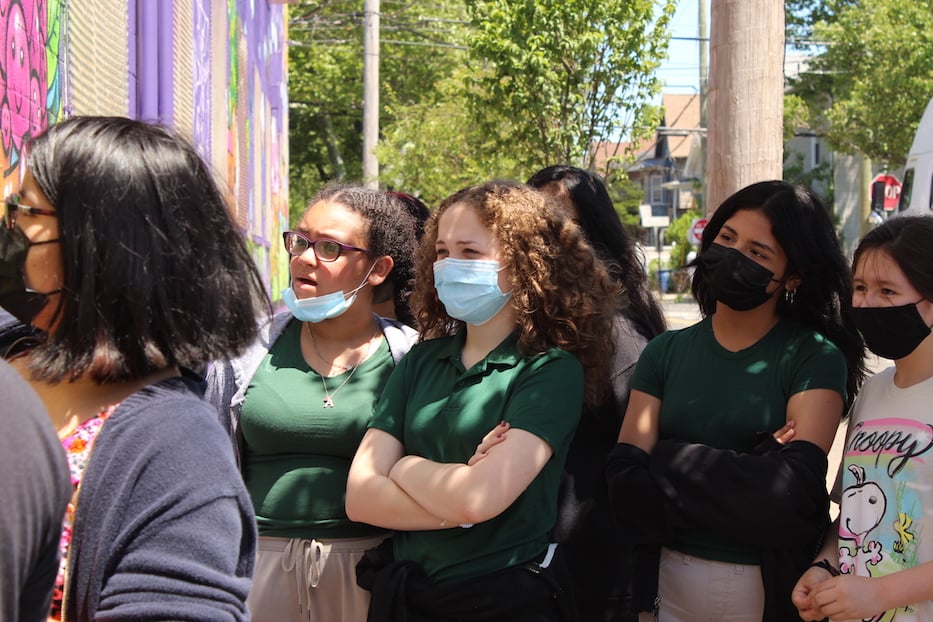 Martinez sixth graders watch as their classmate takes a turn with the spraycan