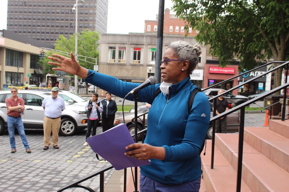 Keynote speaker Joy Burns gestures toward the Amistad Memorial sculpture on Church St.