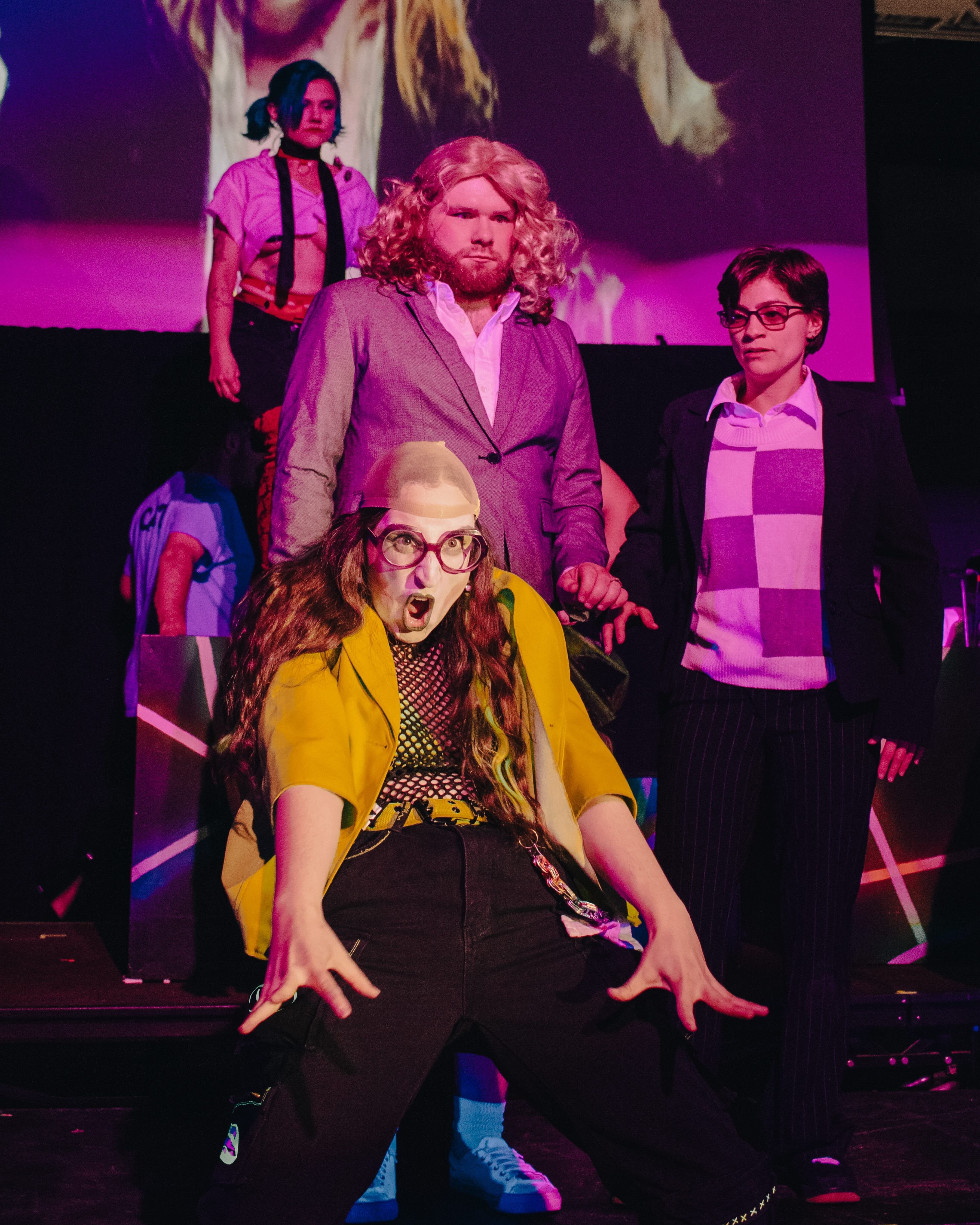 Four actors in loud, risqué outfits dance on stag || Dana Bergenfeld as Riff Raff, Jacob Marks as Janet Weiss, and Cassie Pavain as Brad Majors (Picture credit: Tony DeZinno)