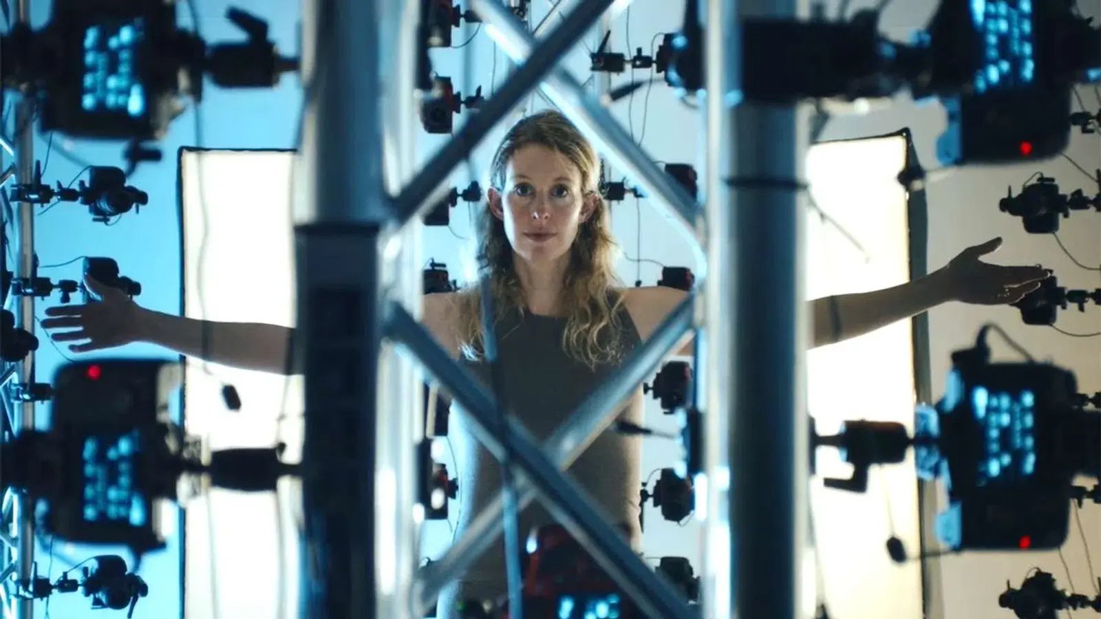 A woman in athletic clothes undergoes a full body scan || Elizabeth Holmes in a still for You Can See Everything (Credit: A24)