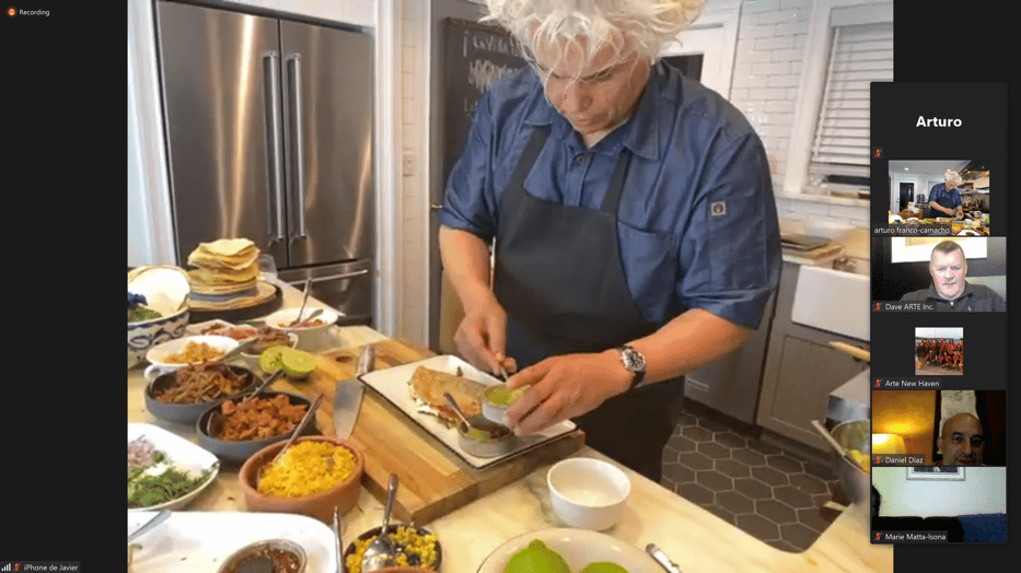 Chef Camacho plating a quesadilla with green salsa