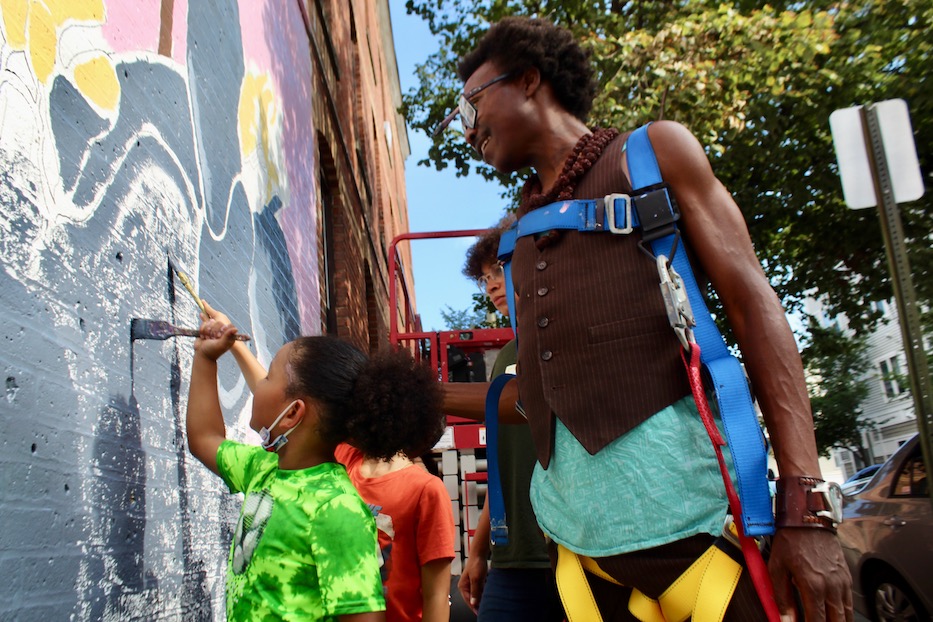 Young Hands Help Orchid Mural Bloom In The Hill