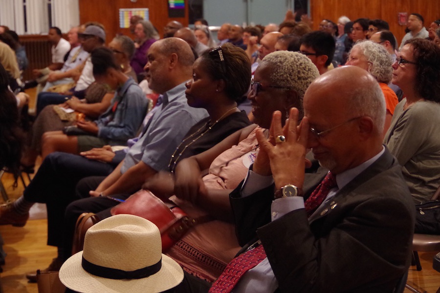 Harp supporters look on as Paca speaks. Lucy Gellman Photo.