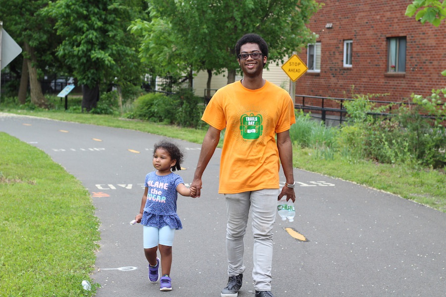Trails Day volunteer Jonathan De Los Santos hangs out with Maddie. A resident of Shelton, he said he enjoyed getting to know the trail a little bit through his volunteer efforts, and would be back.