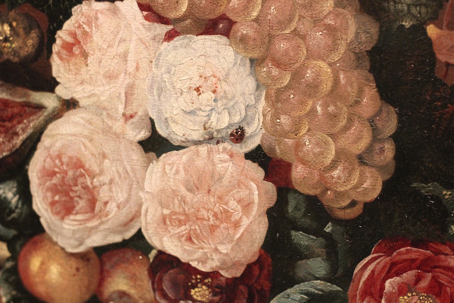 A detail of the work, as a bug braves old flower petails.