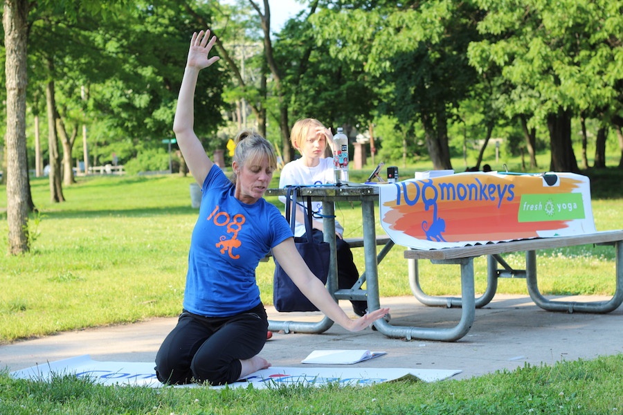  Michelle Morgan: “It’s not about doing the same pose that the person next to you is doing. You do you.” Her son Jack, pictured in the background, welcomed attendees as they trickled into the park.  