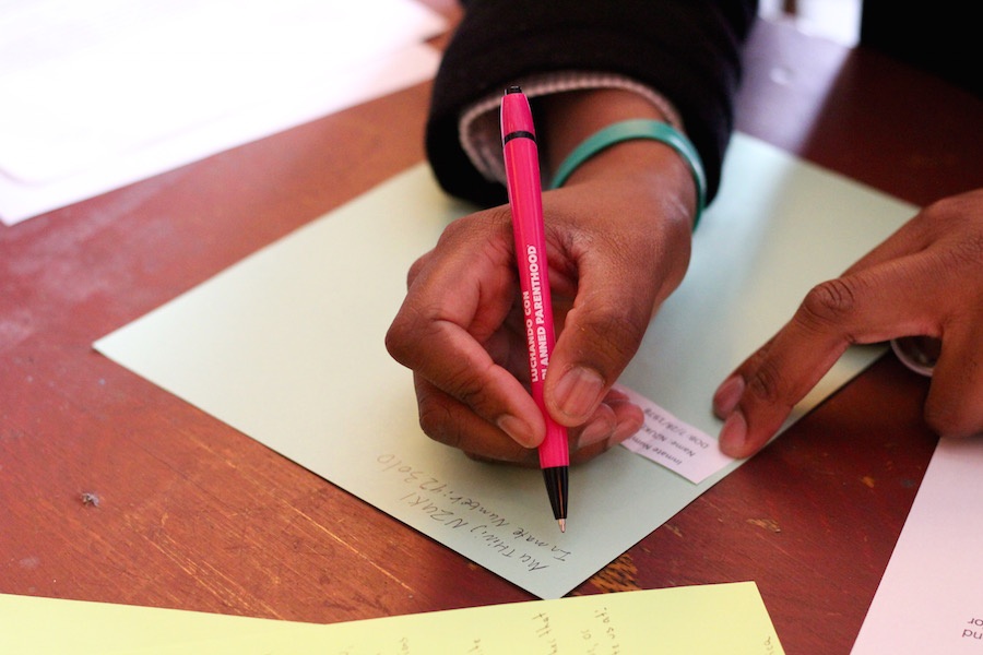Hamden City Council Member Justin Farmer writes to one detainee at York Correctional. As he was writing, facilitator Monica Bunton spoke about the project.