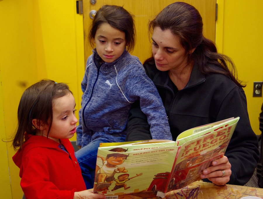 Sarah Miller reads to sons Pablo (blue) and Mateo (red) Cruz.
