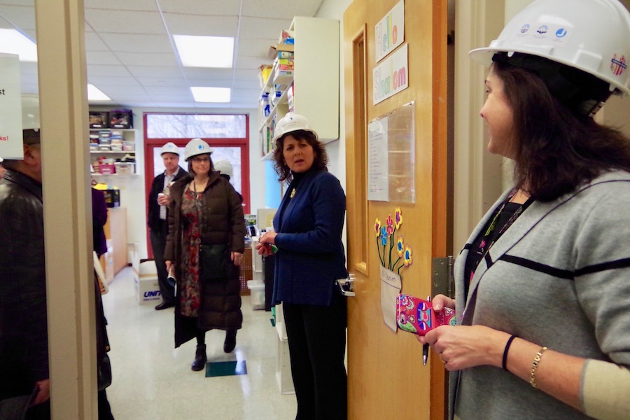 Alperin, with Brander (in the gray and black sweater) in a kindergarten classroom that is