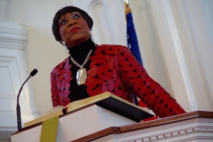  Carroll Brown, longtime organizer of the event, ushers in a moment of silence as attendees listen to the 