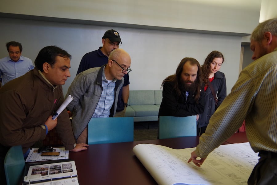From left to right: Viswanath Parajuli, Andrea Corazzini , Bruce Ramirez, Dan Blomberg and Amber Bennett. Pointing to the rendering is architect Brian Cleveland, a representative of Buchanan Architecture.