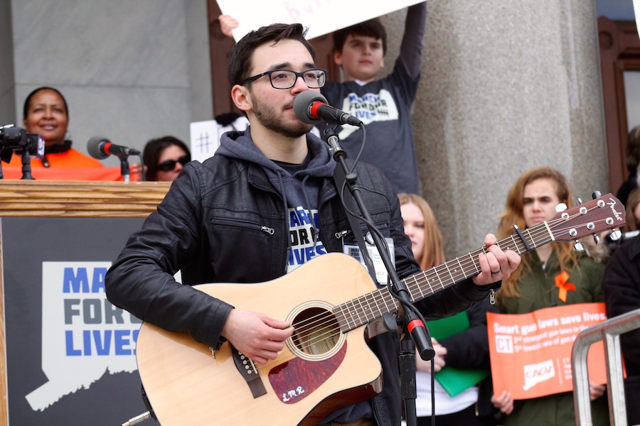 Tyler Suarez, who performed a song written for his aunt midway through the speaking program.