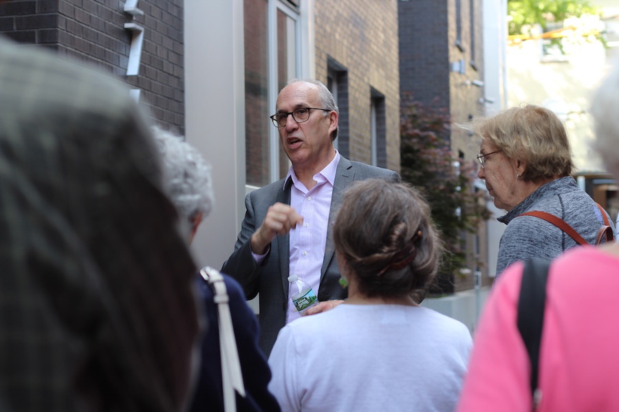  Gardner speaks to members in the mid-block mews.  